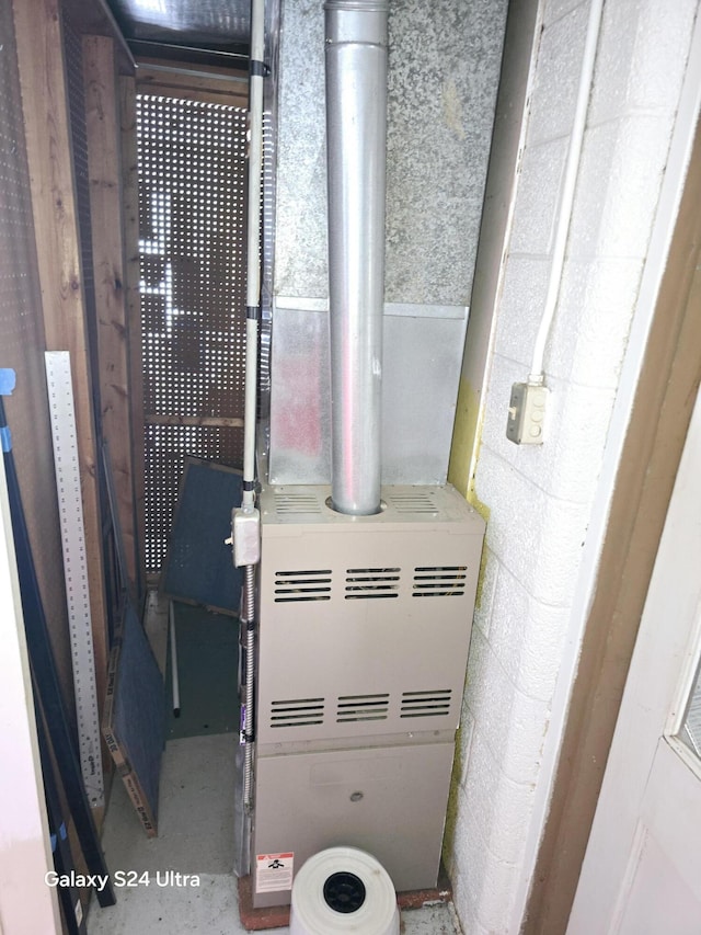 utility room featuring heating unit