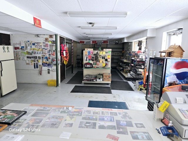 garage featuring a workshop area and white fridge