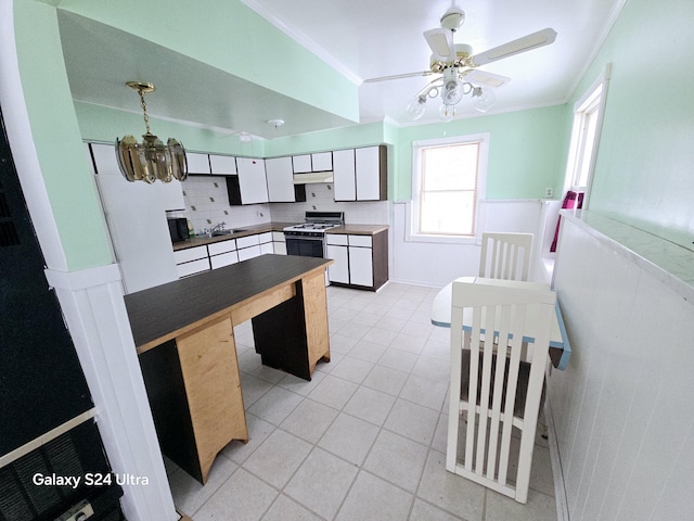 kitchen with white cabinetry, sink, crown molding, and white range with gas cooktop