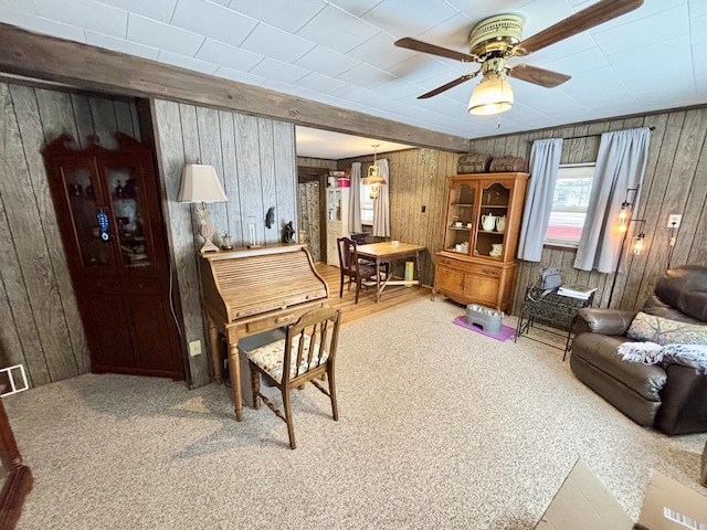 interior space featuring ceiling fan and wooden walls