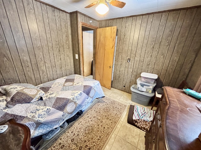 tiled bedroom featuring ceiling fan and wood walls