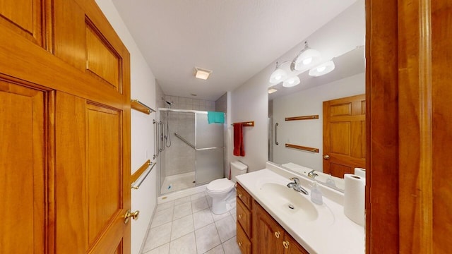 full bathroom featuring toilet, tile patterned flooring, a shower stall, and vanity