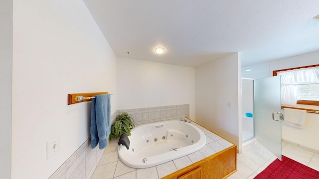 full bath featuring a stall shower, a whirlpool tub, and tile patterned floors