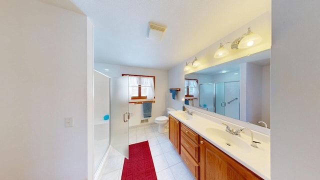 full bathroom with a stall shower, a sink, toilet, and tile patterned floors