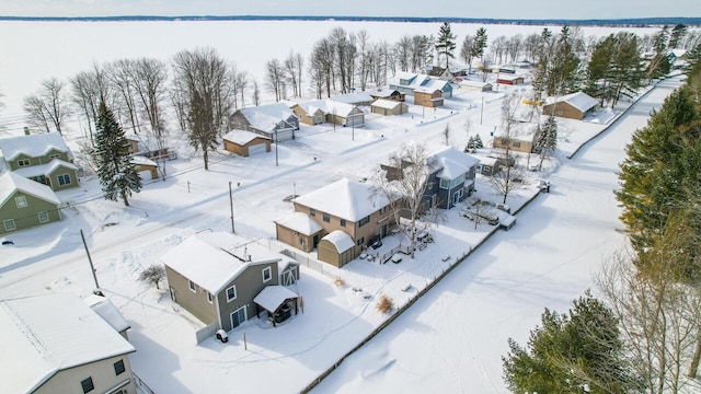 snowy aerial view featuring a residential view