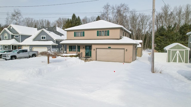 view of front of home featuring an attached garage, covered porch, and a storage shed