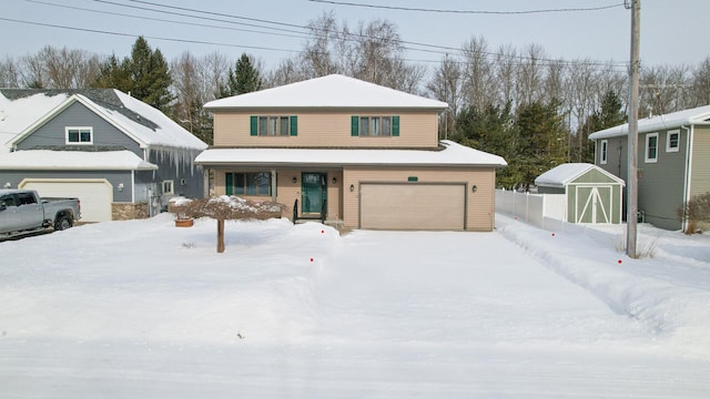 view of front of home featuring a garage, a shed, and an outbuilding