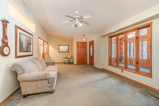 carpeted living room featuring visible vents, baseboards, and a ceiling fan