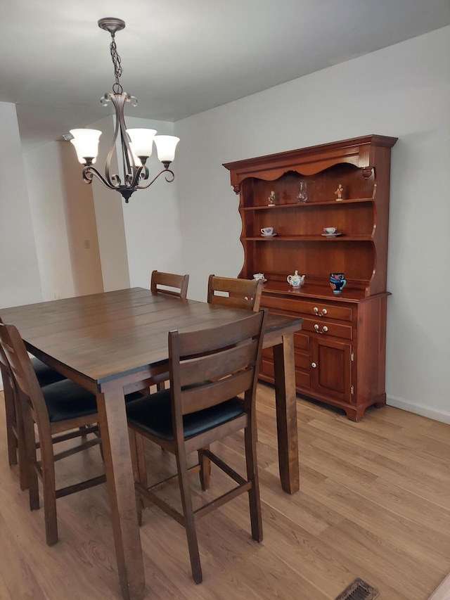 dining area featuring a chandelier and light hardwood / wood-style flooring