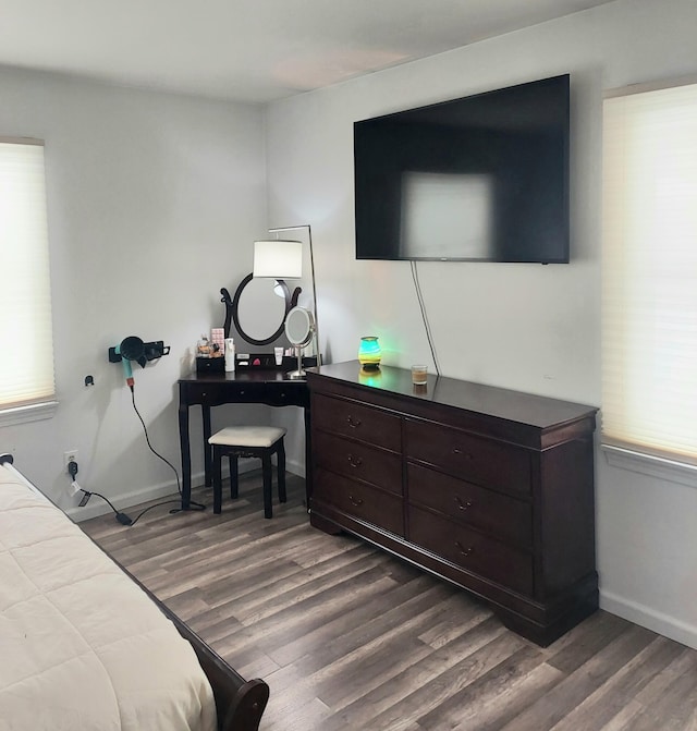 bedroom with dark wood-type flooring