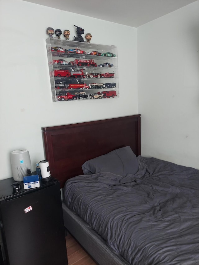 bedroom with dark hardwood / wood-style flooring