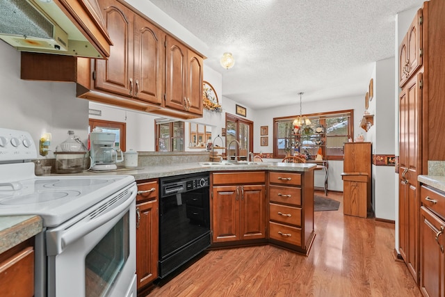 kitchen with dishwasher, range hood, decorative light fixtures, electric stove, and kitchen peninsula