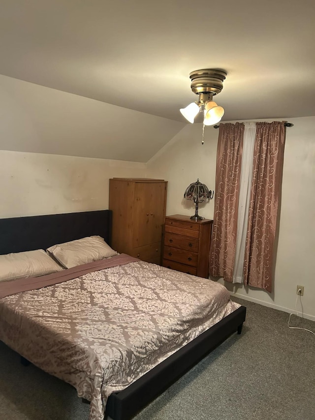 bedroom with lofted ceiling, carpet, and baseboards