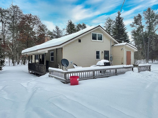 view of snow covered back of property