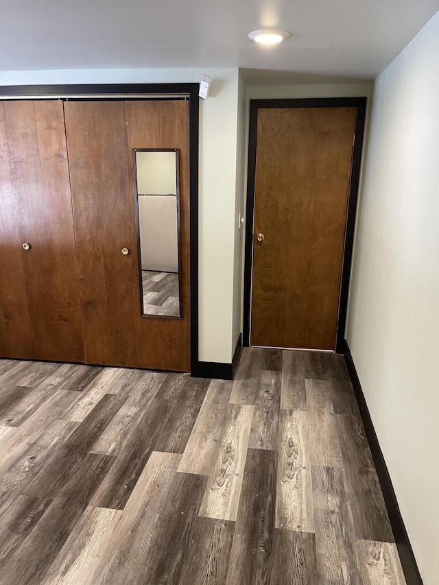 interior space with dark wood-type flooring and a closet