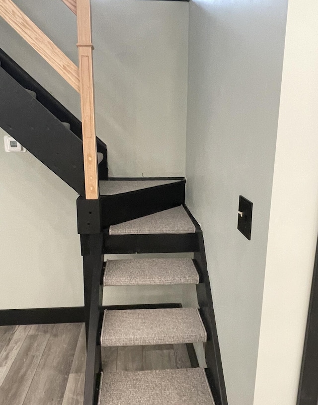 stairs with hardwood / wood-style floors