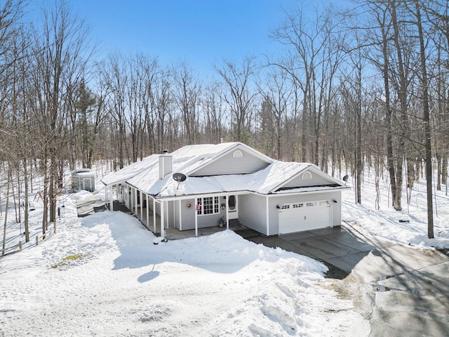 view of front of property with a garage and a chimney