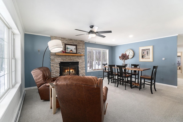 living area with a stone fireplace, a baseboard radiator, light carpet, baseboards, and ornamental molding