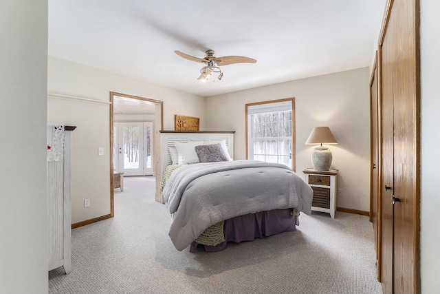 bedroom featuring multiple windows, baseboards, and light colored carpet