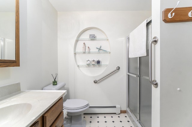 bathroom with a baseboard radiator, toilet, vanity, a shower stall, and tile patterned floors