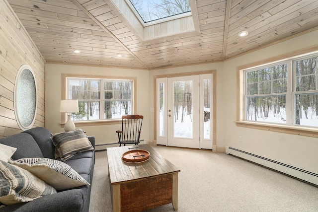 living room with a baseboard heating unit, wooden ceiling, carpet floors, and lofted ceiling with skylight