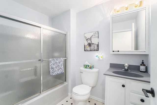 full bathroom featuring baseboards, combined bath / shower with glass door, vanity, and toilet