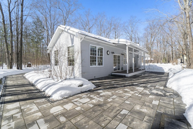 snow covered house with covered porch