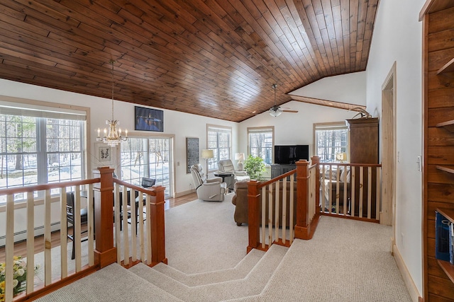 living area featuring vaulted ceiling, wooden ceiling, a wealth of natural light, and a notable chandelier