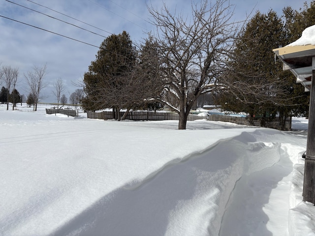 snowy yard with fence