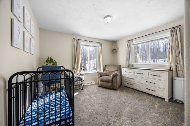 bedroom featuring a textured ceiling, dark colored carpet, and baseboards