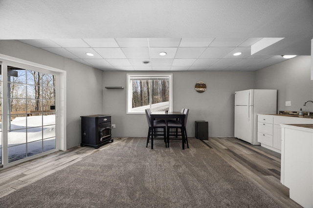 dining room featuring a drop ceiling and wood finished floors