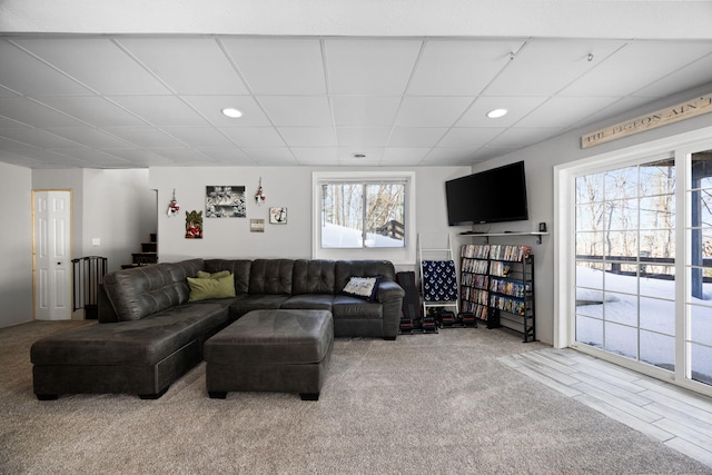 living area featuring a paneled ceiling, stairs, carpet flooring, and recessed lighting