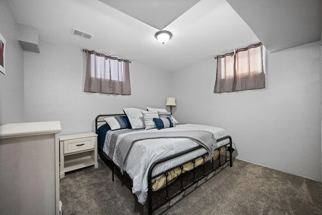 bedroom featuring dark carpet and visible vents