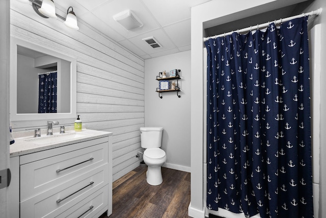 bathroom with a shower with curtain, visible vents, toilet, and wood finished floors