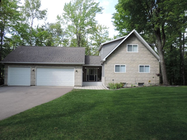 view of front of home with a garage, a front yard, stone siding, and driveway