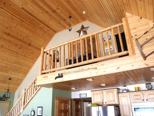 details featuring wood ceiling, light brown cabinetry, freestanding refrigerator, and pendant lighting