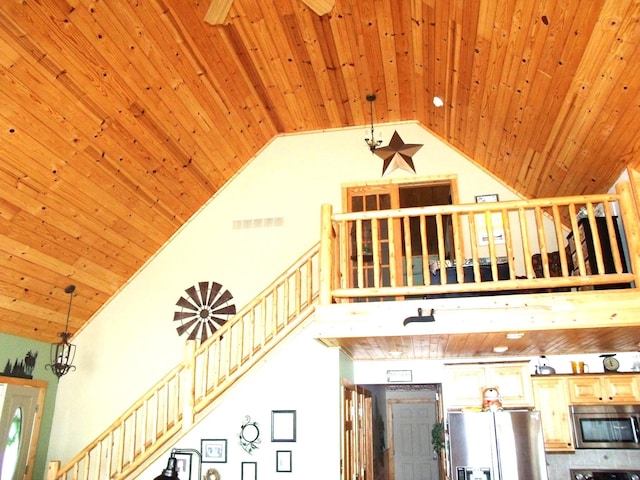 interior space with wood ceiling, visible vents, high vaulted ceiling, and ceiling fan