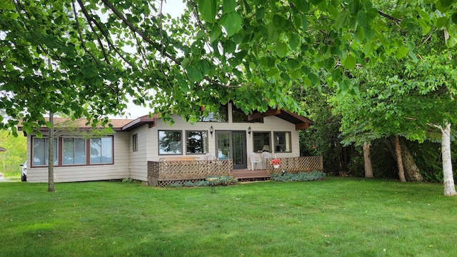 view of front of house featuring a front yard and a wooden deck