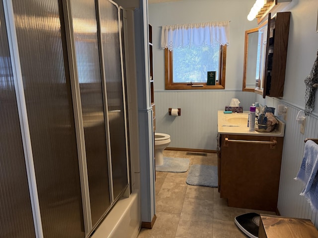 bathroom featuring a wainscoted wall, tile patterned flooring, visible vents, and vanity