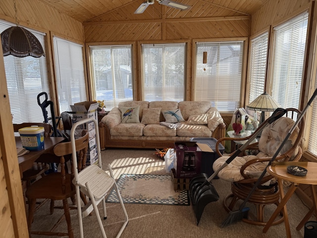 sunroom with lofted ceiling, wood ceiling, and a ceiling fan