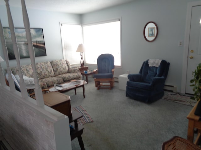 carpeted living area with baseboard heating