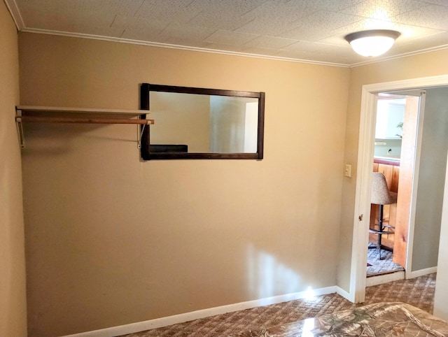 unfurnished bedroom with crown molding and baseboards