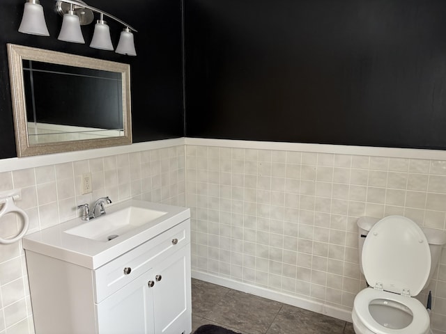 bathroom featuring tile walls, tile patterned flooring, vanity, and toilet