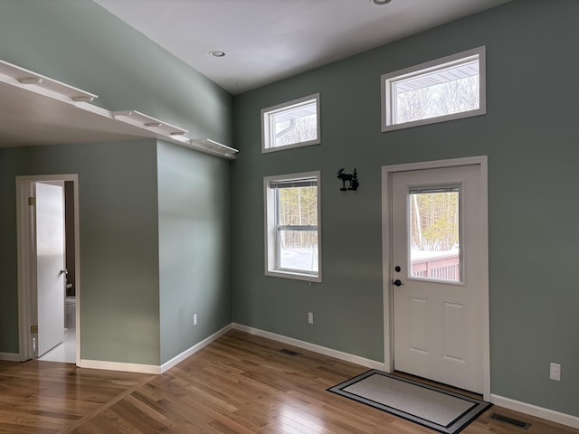 entrance foyer featuring wood finished floors, visible vents, and baseboards