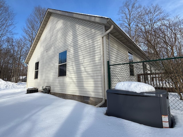 view of snow covered exterior featuring a wooden deck