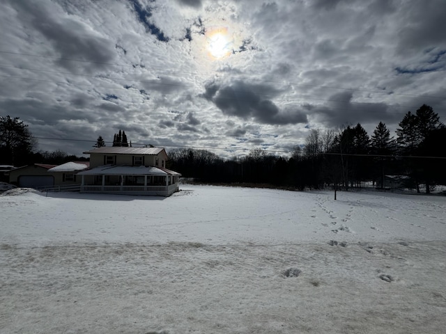 yard covered in snow featuring a sunroom