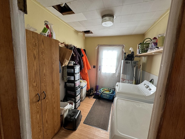 laundry room with laundry area, light wood-style flooring, water heater, and separate washer and dryer