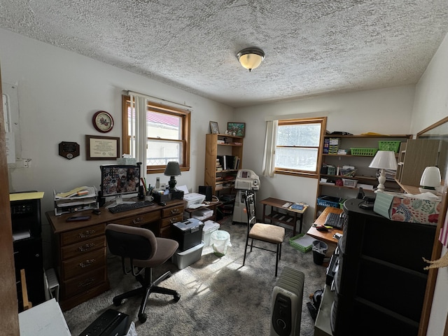 home office featuring a textured ceiling and carpet flooring