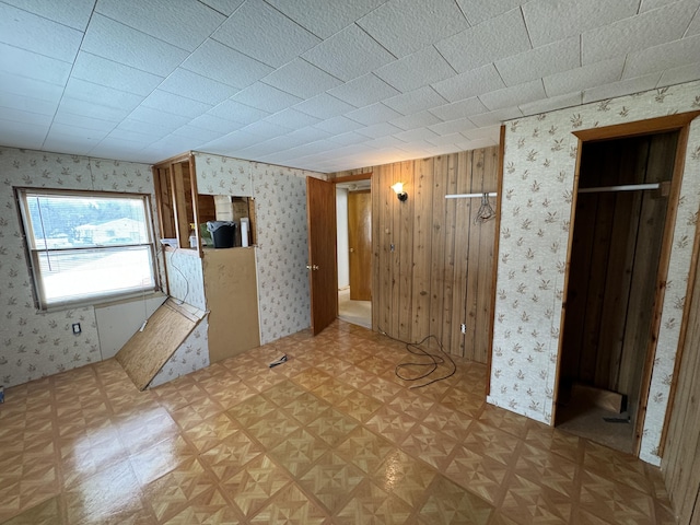 kitchen featuring wallpapered walls and light floors