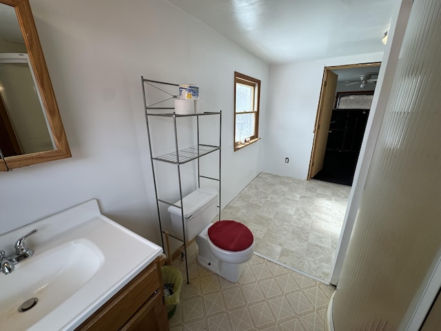 full bathroom featuring ceiling fan, vanity, toilet, and tile patterned floors